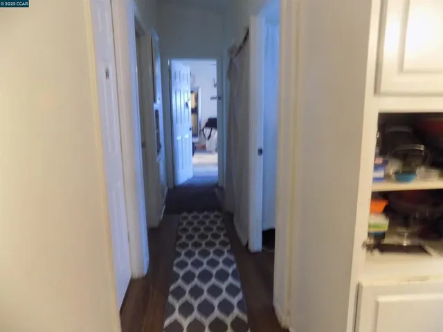 a hallway with a dining table and chair