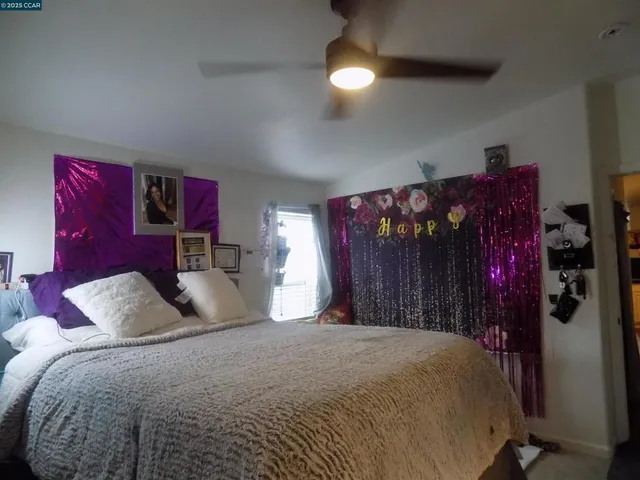 a bedroom with a large bed and a chandelier