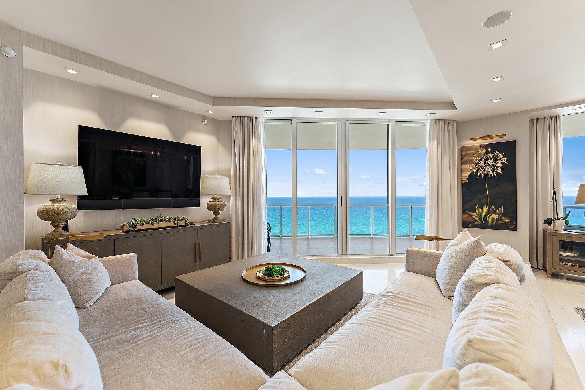 2700 North Ocean Drive, Unit 2304B Singer Island, FL 33404 - Photo 11 of 73 a living room with furniture and a flat screen tv