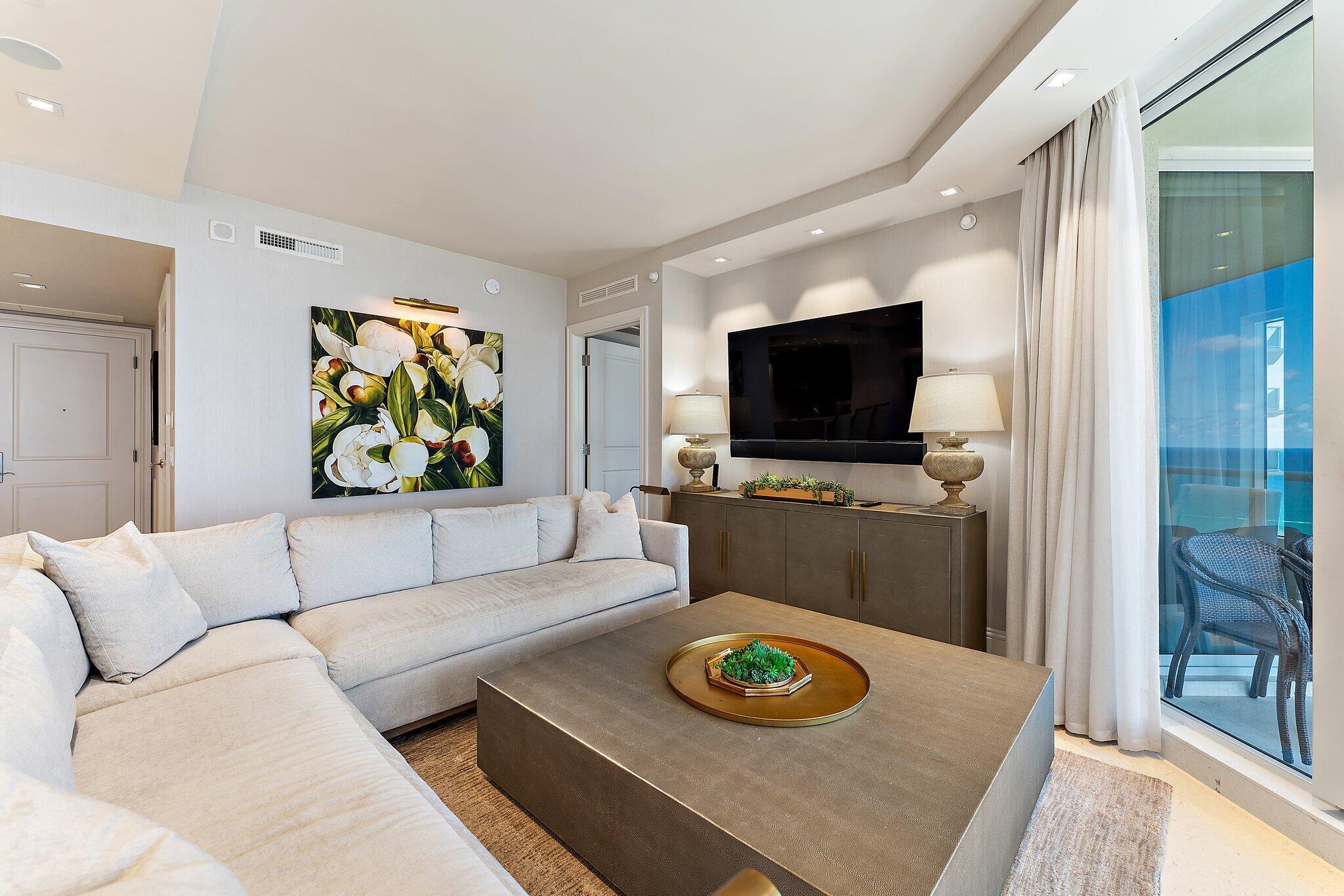 2700 North Ocean Drive, Unit 2304B Singer Island, FL 33404 - Photo 13 of 73 a living room with furniture and a flat screen tv