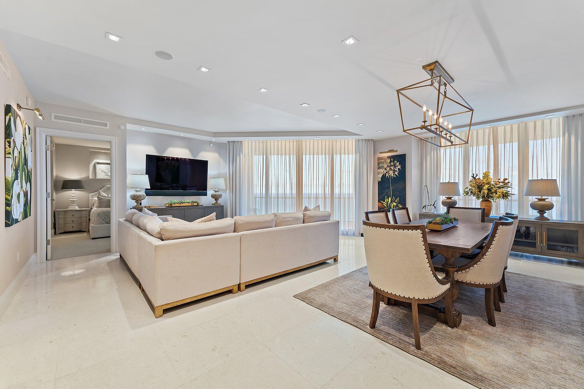 2700 North Ocean Drive, Unit 2304B Singer Island, FL 33404 - Photo 17 of 73 a living room with furniture a flat screen tv and a window