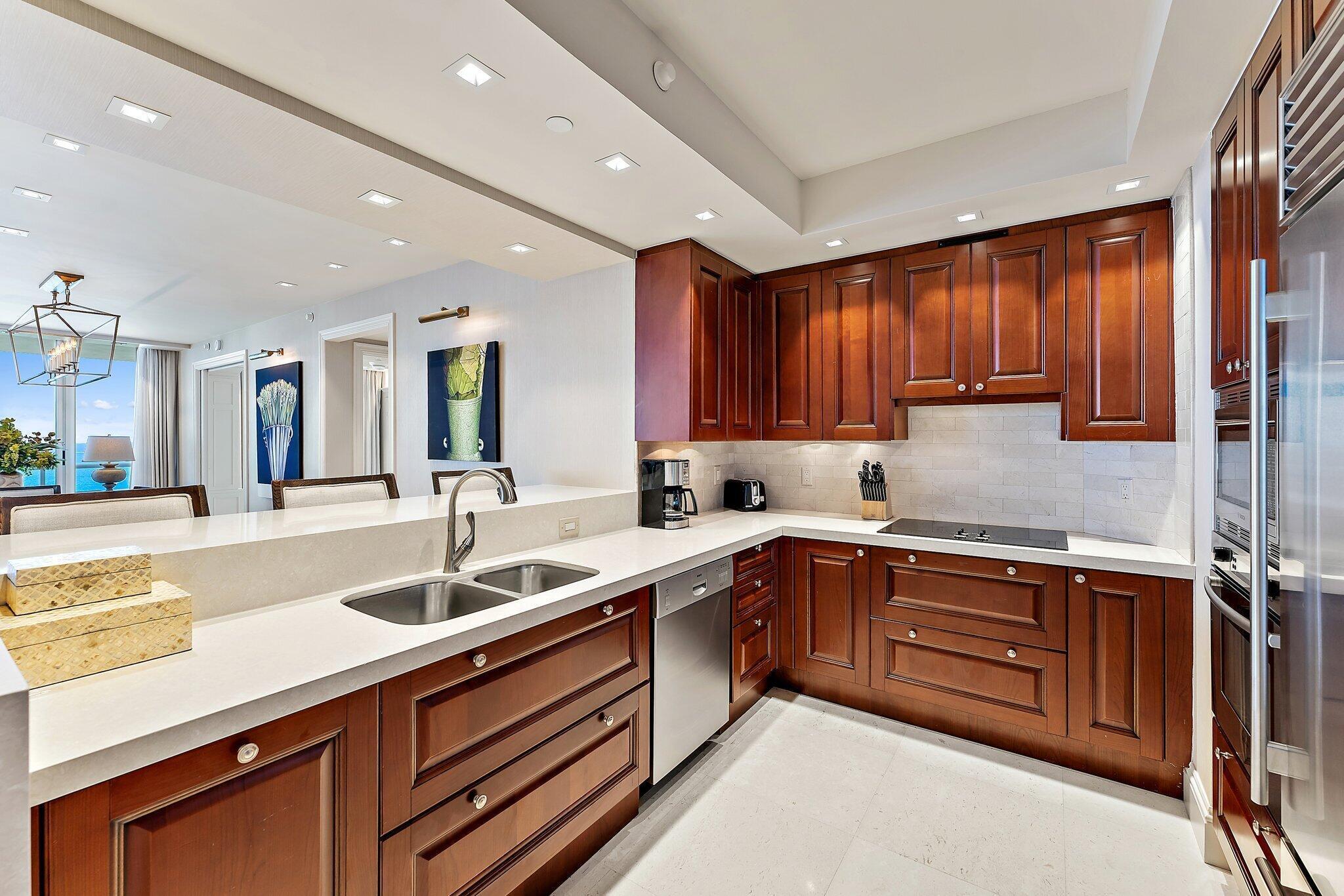 2700 North Ocean Drive, Unit 2304B Singer Island, FL 33404 - Photo 2 of 73 a kitchen with a sink appliances and cabinets