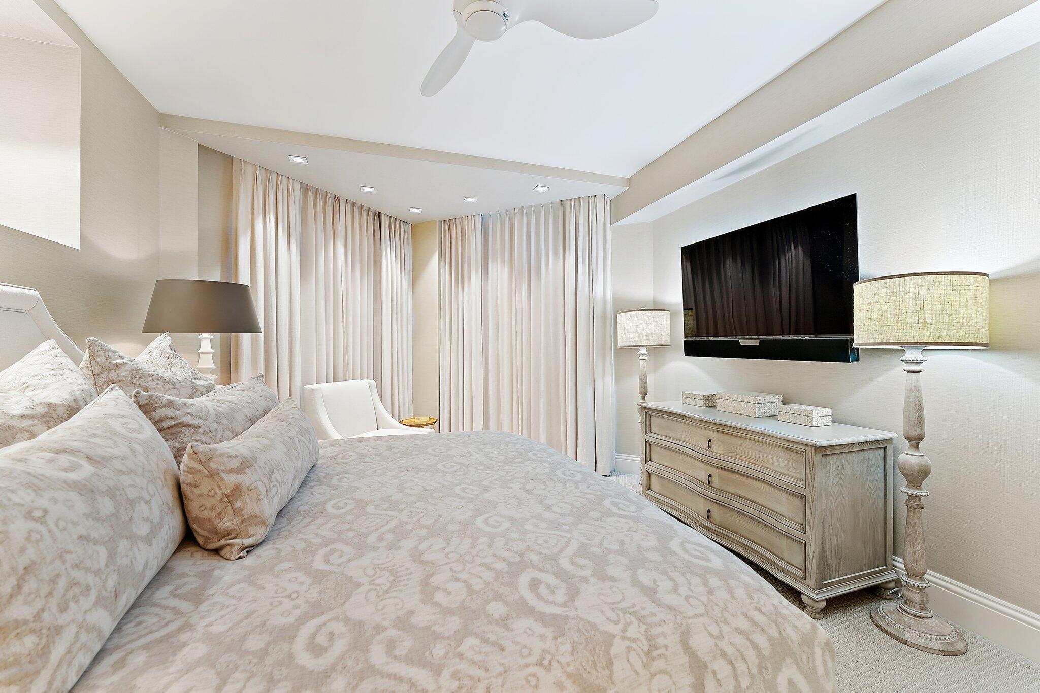 2700 North Ocean Drive, Unit 2304B Singer Island, FL 33404 - Photo 26 of 73 a spacious bedroom with a bed and a flat screen tv