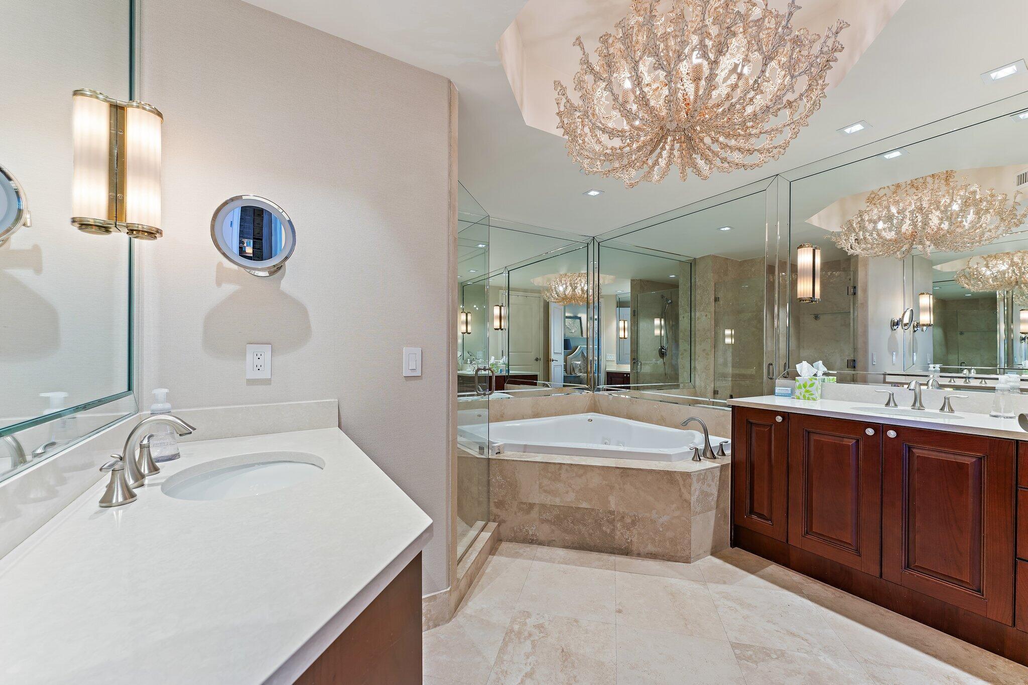 2700 North Ocean Drive, Unit 2304B Singer Island, FL 33404 - Photo 29 of 73 a spacious bathroom with a sink a large mirror and a bathtub