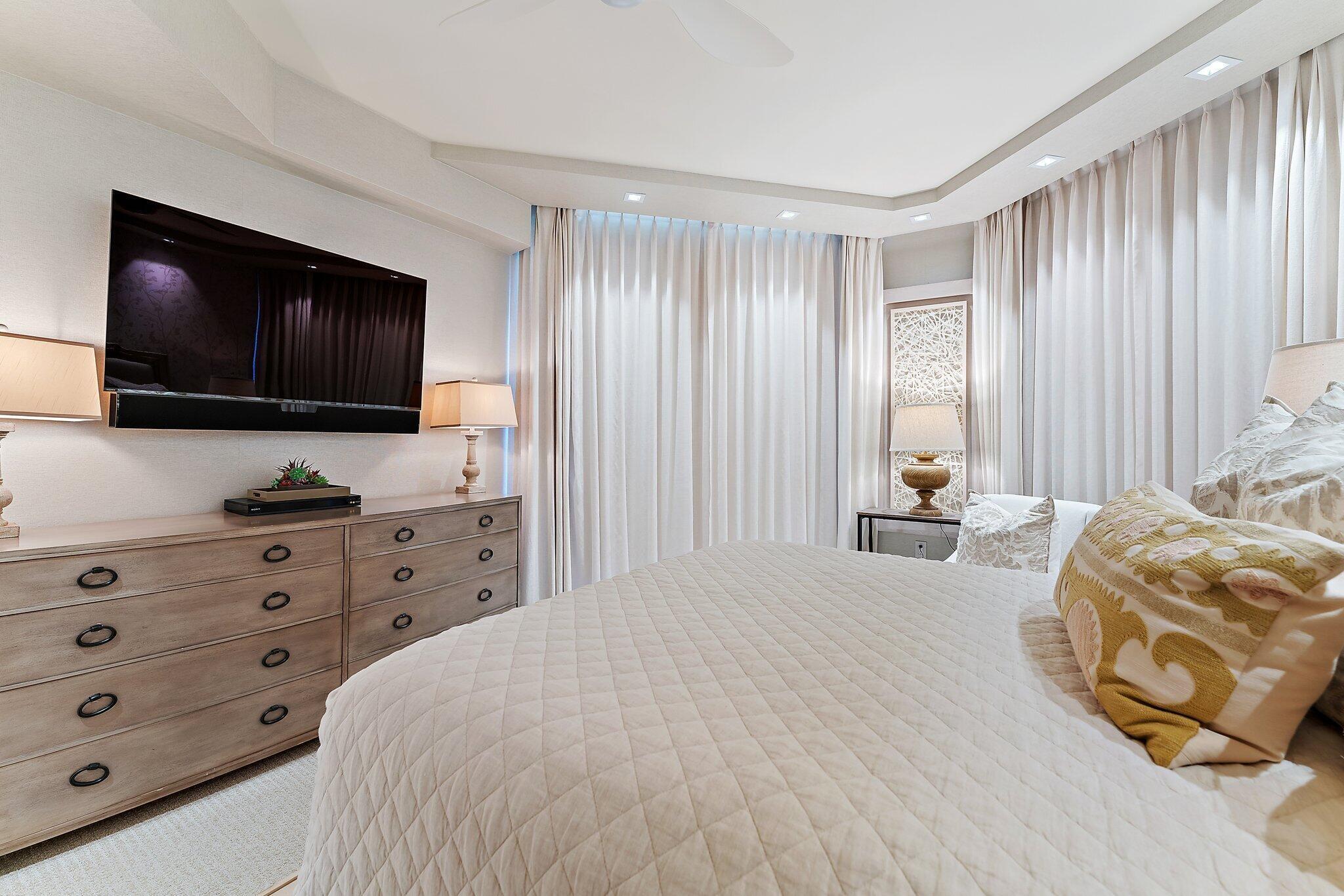 2700 North Ocean Drive, Unit 2304B Singer Island, FL 33404 - Photo 39 of 73 a bedroom with a bed and a flat screen tv in it