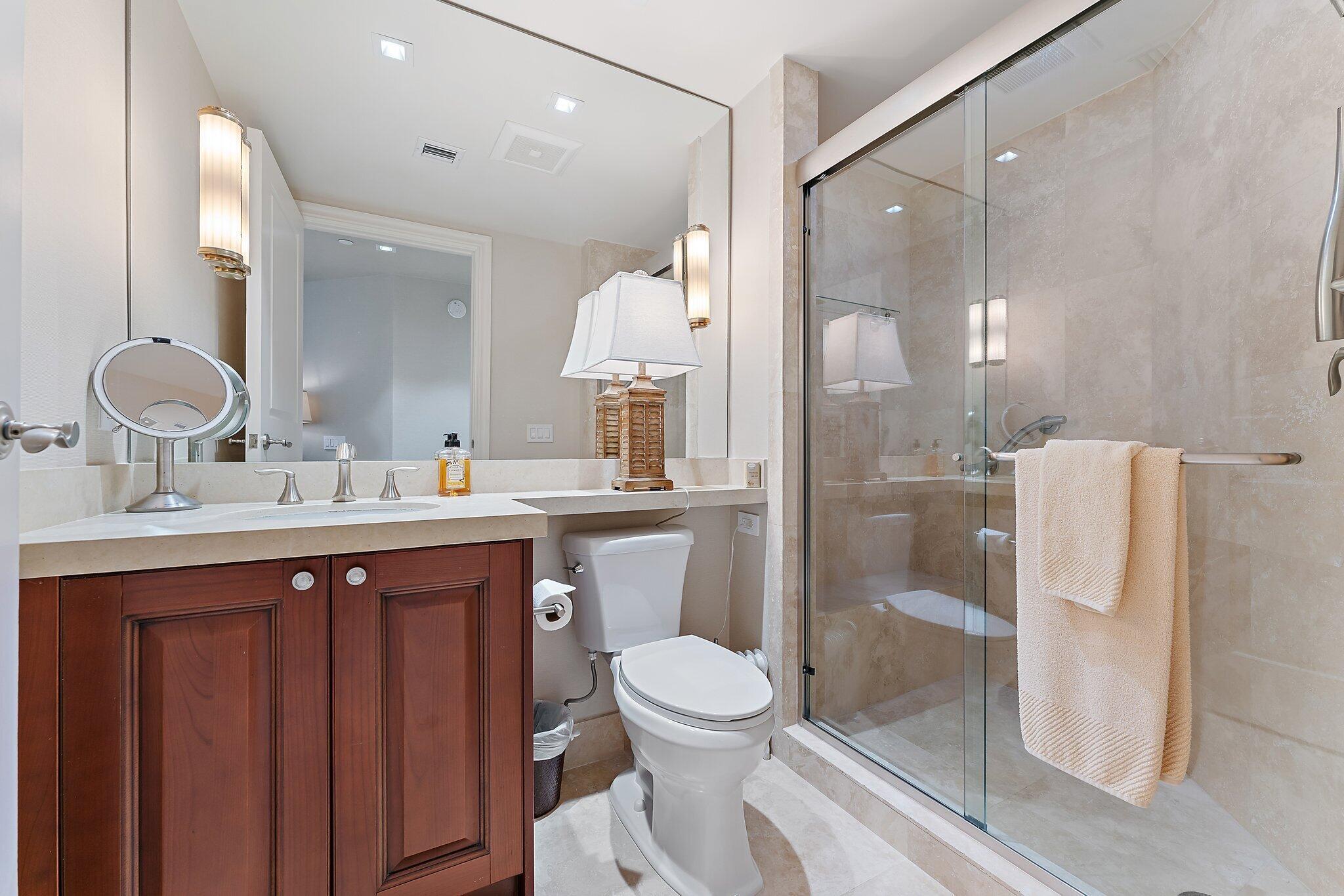 2700 North Ocean Drive, Unit 2304B Singer Island, FL 33404 - Photo 41 of 73 a bathroom with a toilet a sink and a large mirror