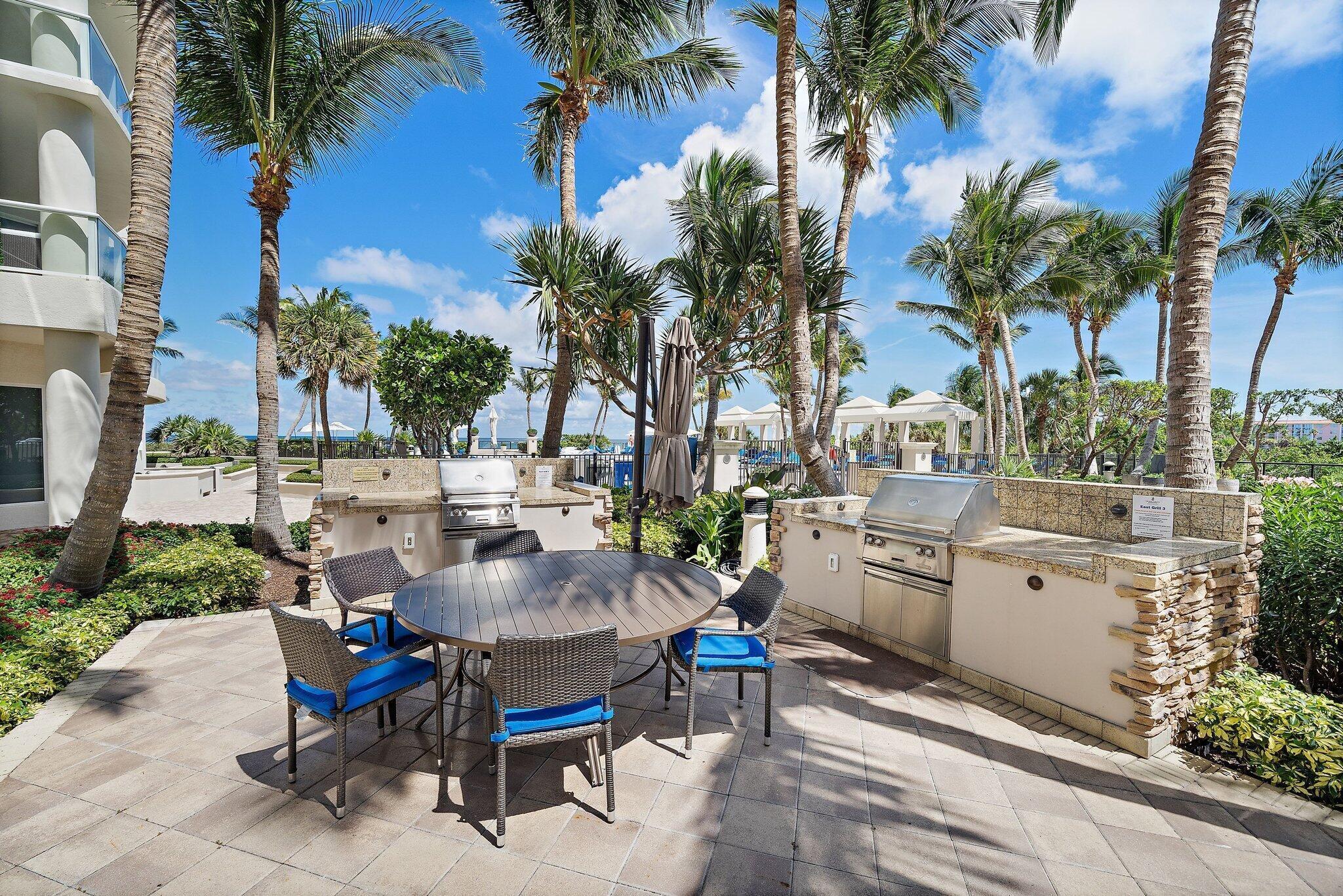 2700 North Ocean Drive, Unit 2304B Singer Island, FL 33404 - Photo 58 of 73 a view of a patio with table and chairs potted plants and palm tree