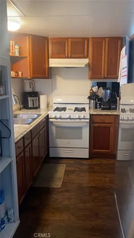 a kitchen with a stove top oven sink and cabinets