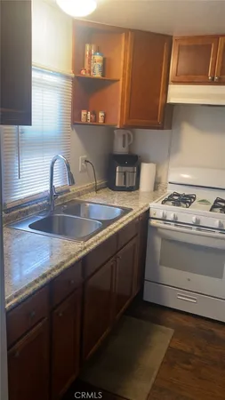 a kitchen with a sink cabinets and a stove top oven