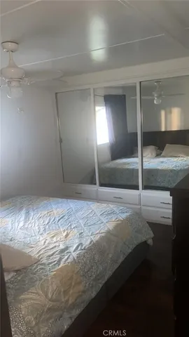 a bedroom with a bed and a mirror