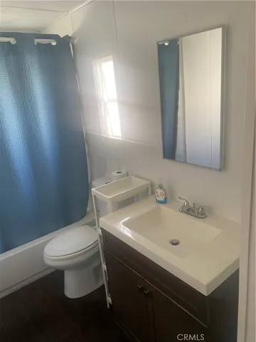 a white toilet sitting next to a bathroom sink