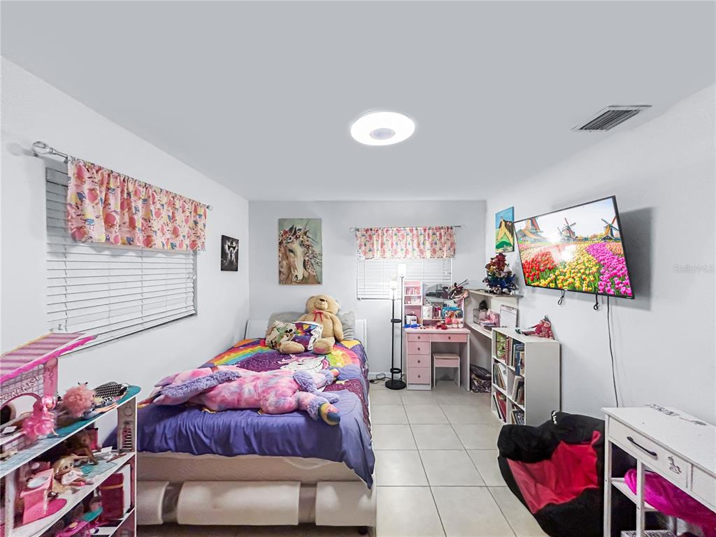 608 West Nelson Street Tavares, FL 32778 - Photo 13 of 17 a living room with furniture and a flat screen tv