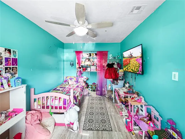a bedroom with furniture and a flat screen tv