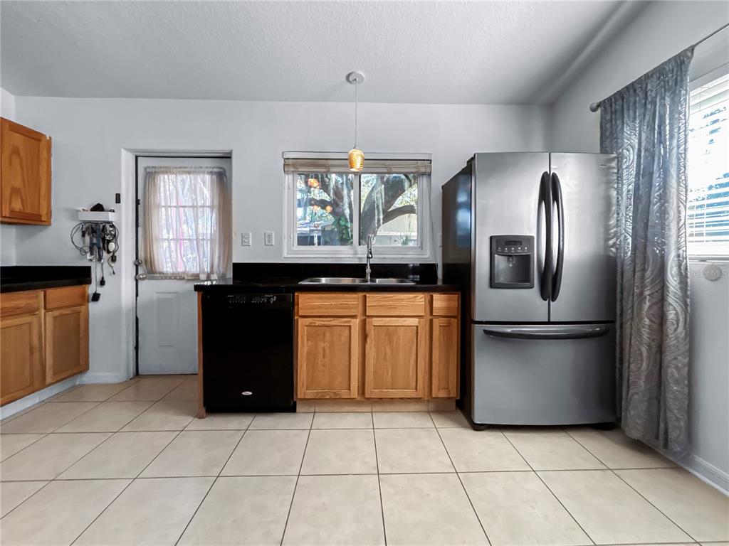 608 West Nelson Street Tavares, FL 32778 - Photo 2 of 17 a kitchen with a refrigerator sink and cabinets