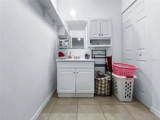 a utility room with cabinets dryer and washer