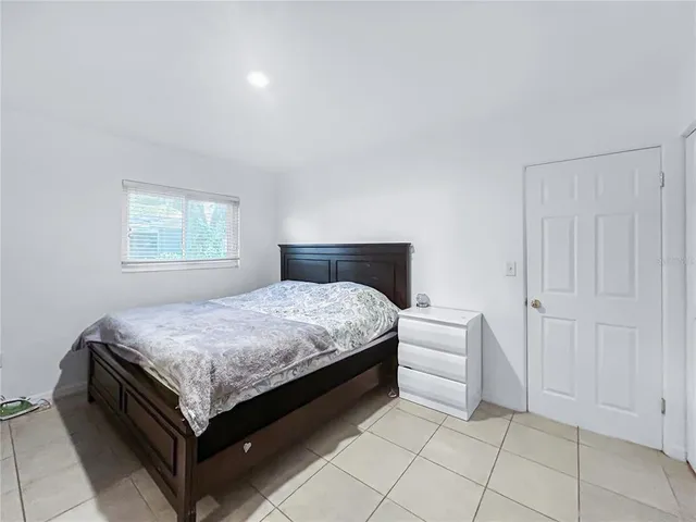 a bedroom with a bed and window