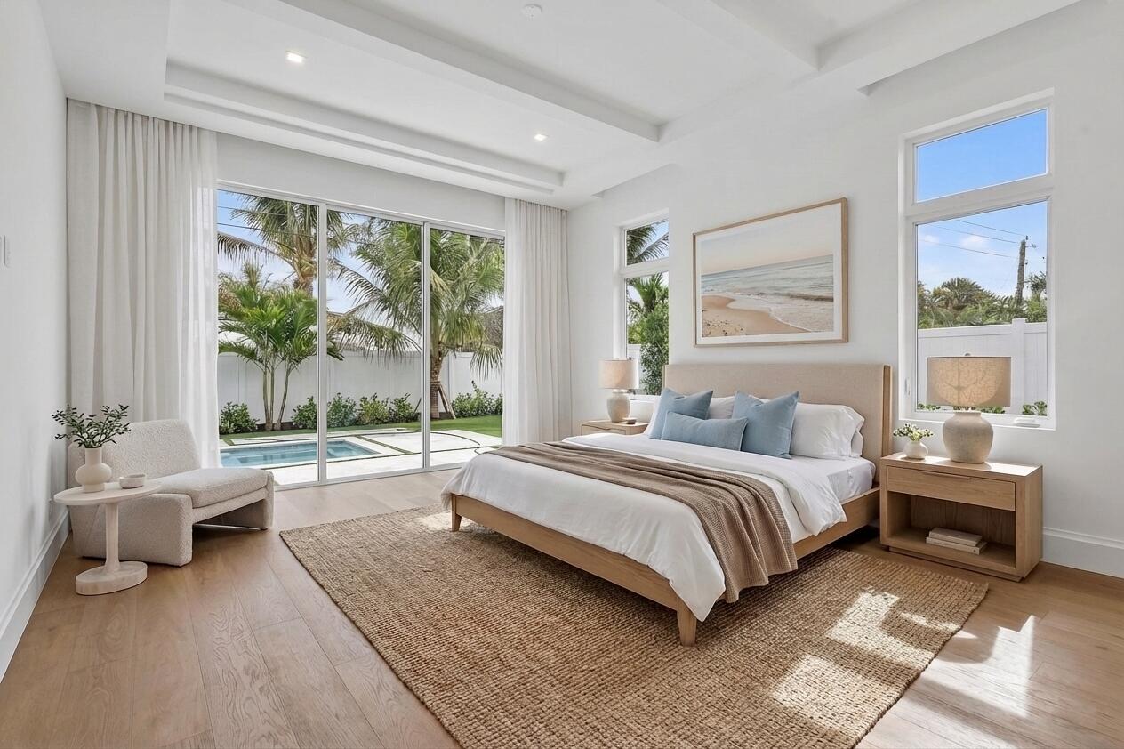 192 River Drive Jupiter, FL 33469 - Photo 13 of 45 a spacious bedroom with a bed and a couch