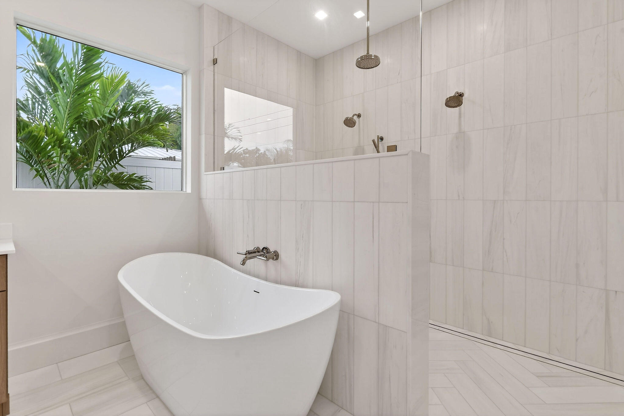 192 River Drive Jupiter, FL 33469 - Photo 15 of 45 a white bath tub sitting in a bathroom next to a window