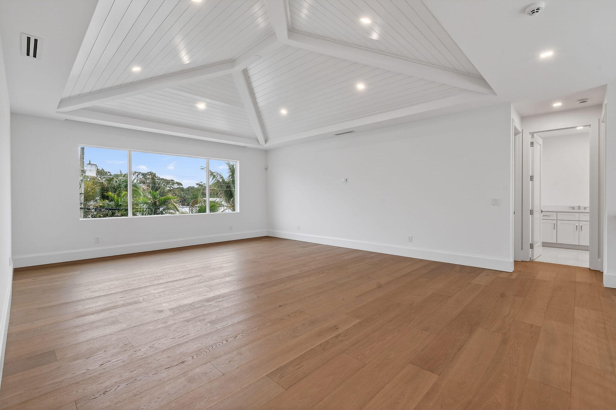 192 River Drive Jupiter, FL 33469 - Photo 20 of 45 an empty room with wooden floor and windows