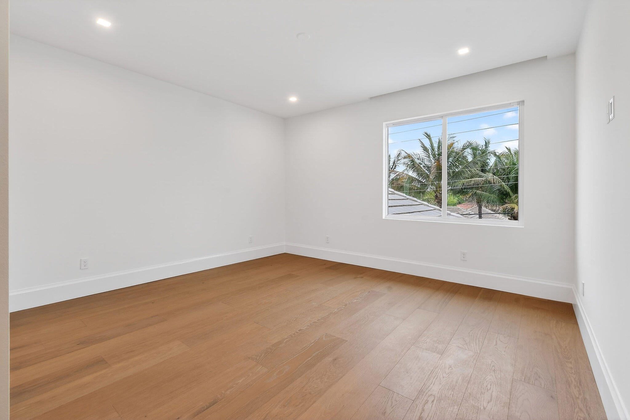 192 River Drive Jupiter, FL 33469 - Photo 22 of 45 an empty room with wooden floor and window