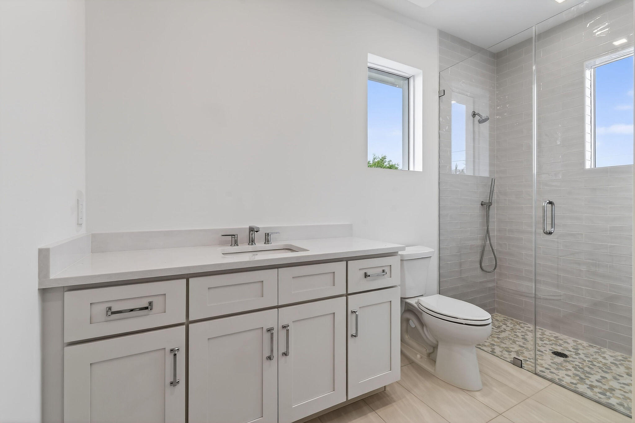 192 River Drive Jupiter, FL 33469 - Photo 27 of 45 a spacious bathroom with a toilet a sink a mirror and a shower