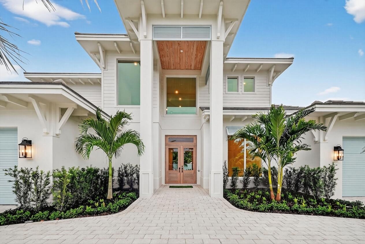 192 River Drive Jupiter, FL 33469 - Photo 3 of 45 a front view of a house with a yard