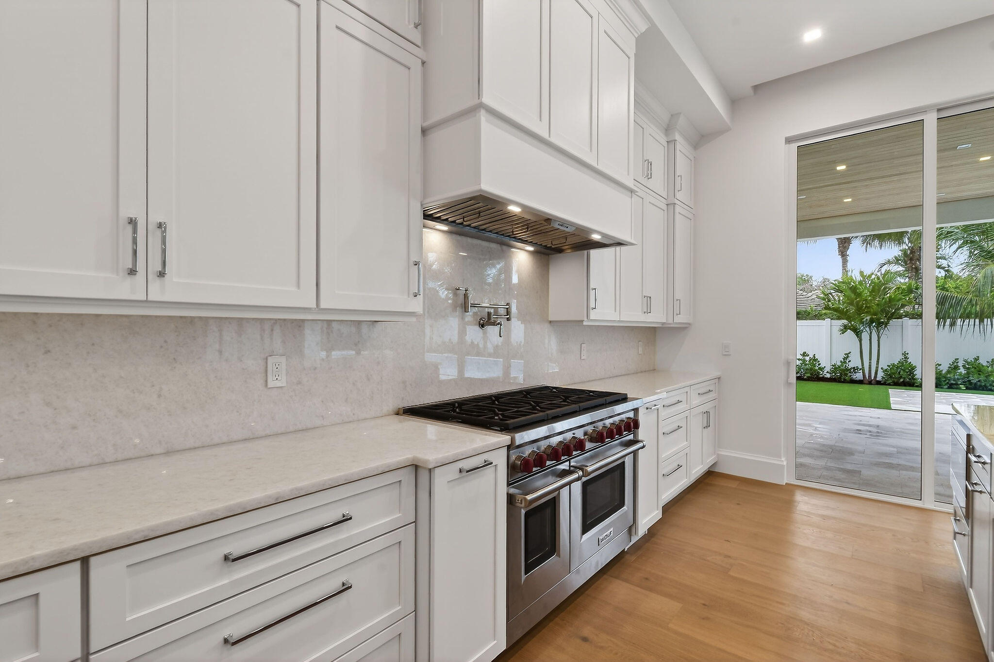 192 River Drive Jupiter, FL 33469 - Photo 10 of 45 a kitchen with stainless steel appliances a stove and a white cabinets