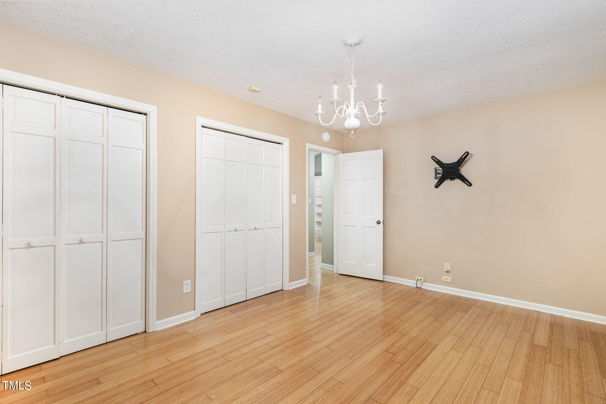 7831 Breckon Way Raleigh, NC 27615 - Photo 23 of 29 wooden floor in an empty room with a window