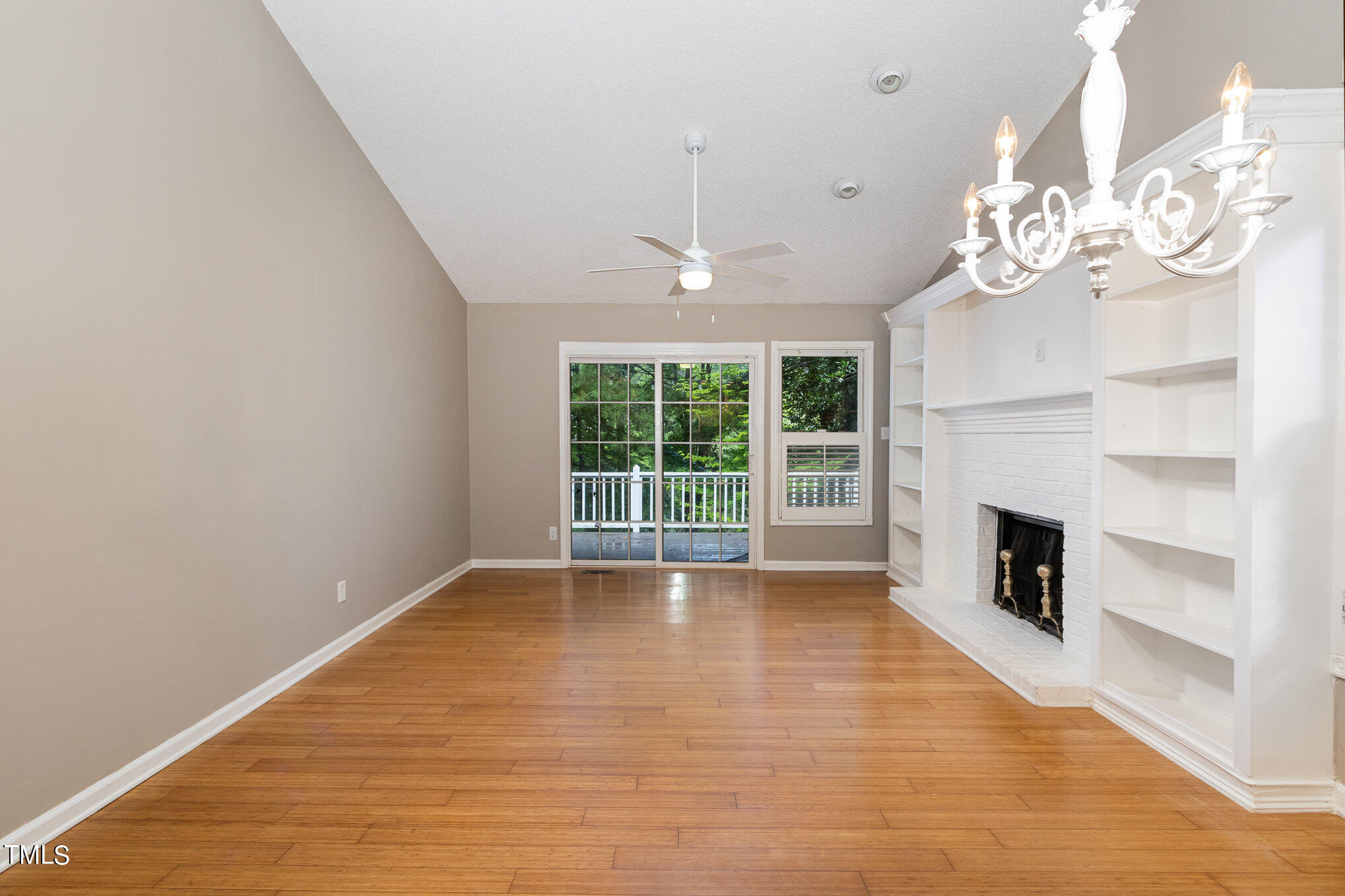 7831 Breckon Way Raleigh, NC 27615 - Photo 4 of 29 a view of an empty room with a fireplace and a window