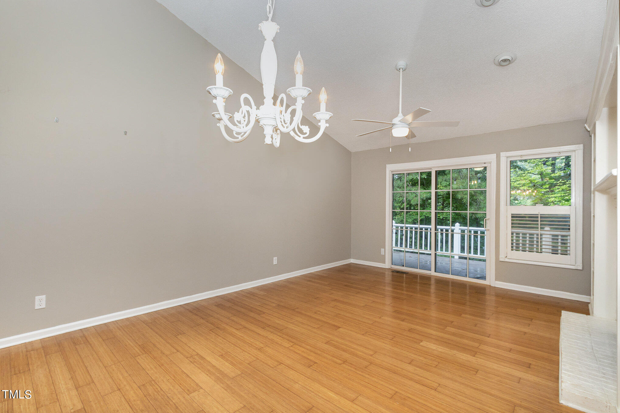 7831 Breckon Way Raleigh, NC 27615 - Photo 5 of 29 wooden floor in an empty room with a window