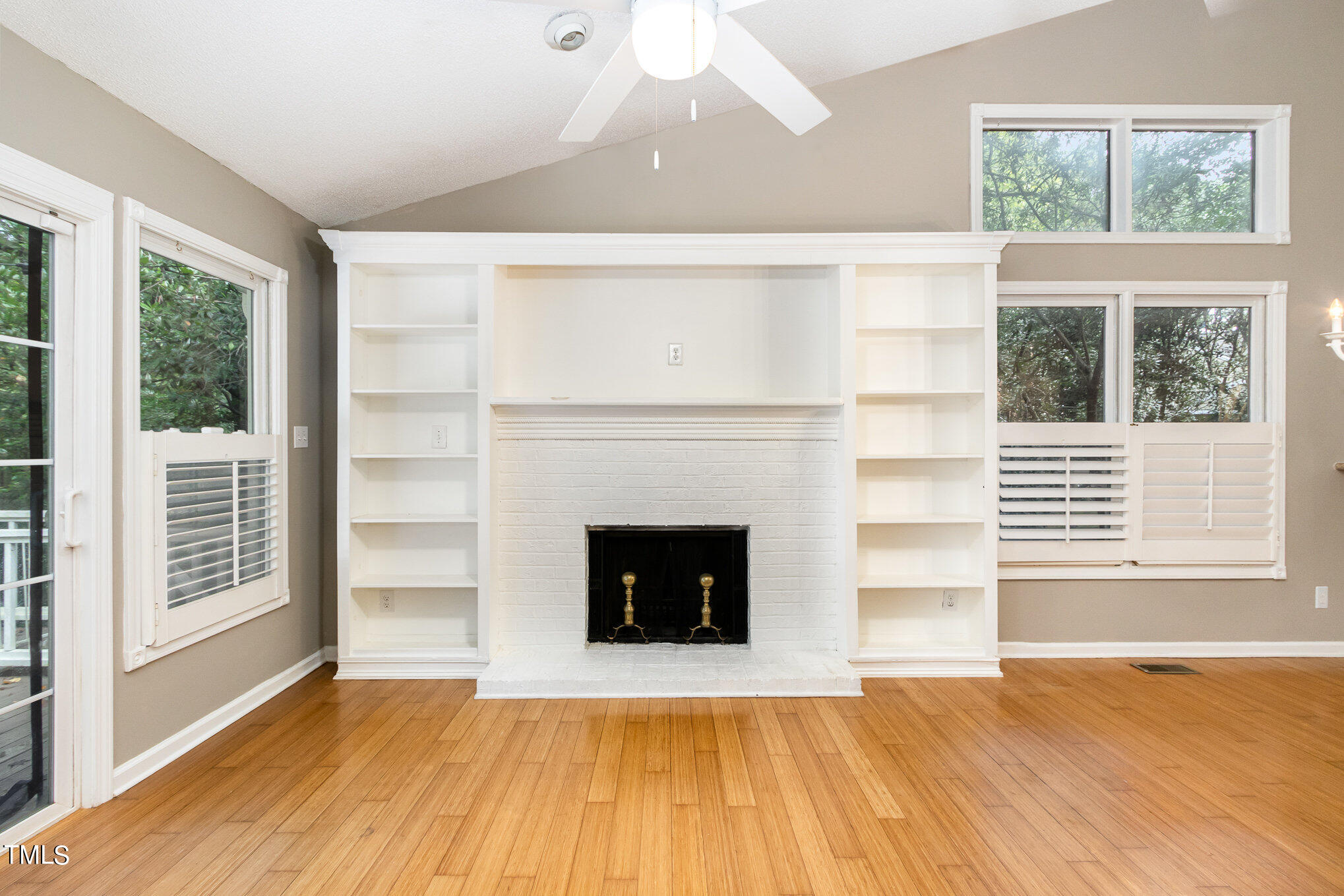 7831 Breckon Way Raleigh, NC 27615 - Photo 6 of 29 a view of an empty room with a fireplace and a window