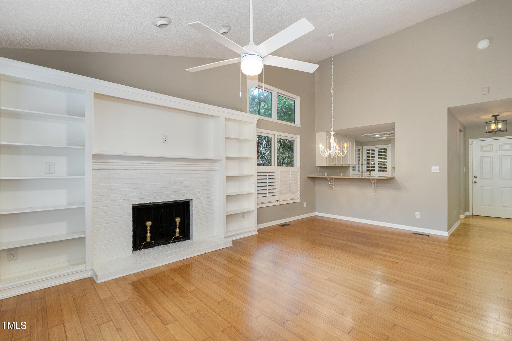 7831 Breckon Way Raleigh, NC 27615 - Photo 7 of 29 a view of an empty room with a fireplace and a window