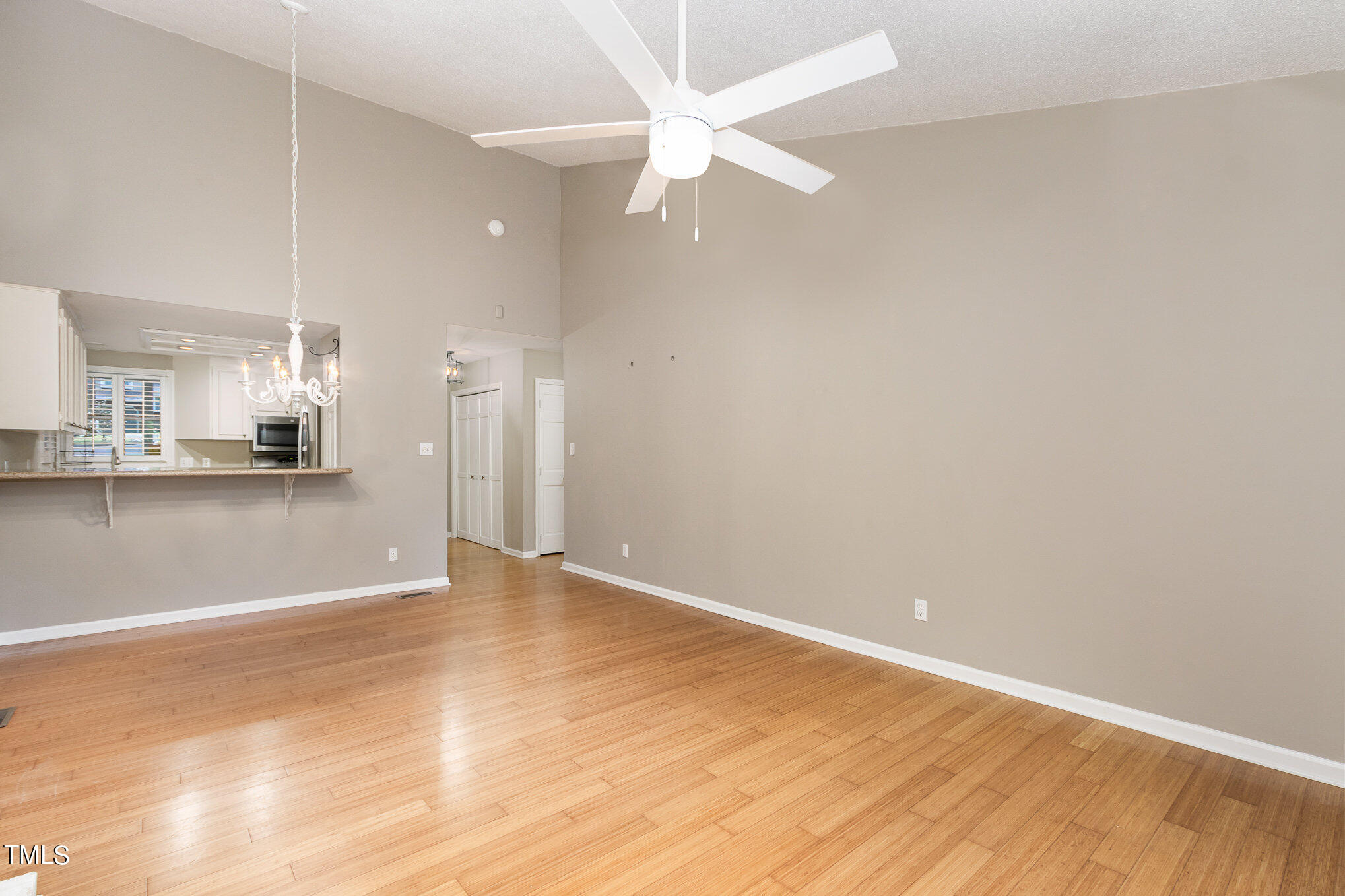 7831 Breckon Way Raleigh, NC 27615 - Photo 8 of 29 a view of an empty room with kitchen and kitchen view