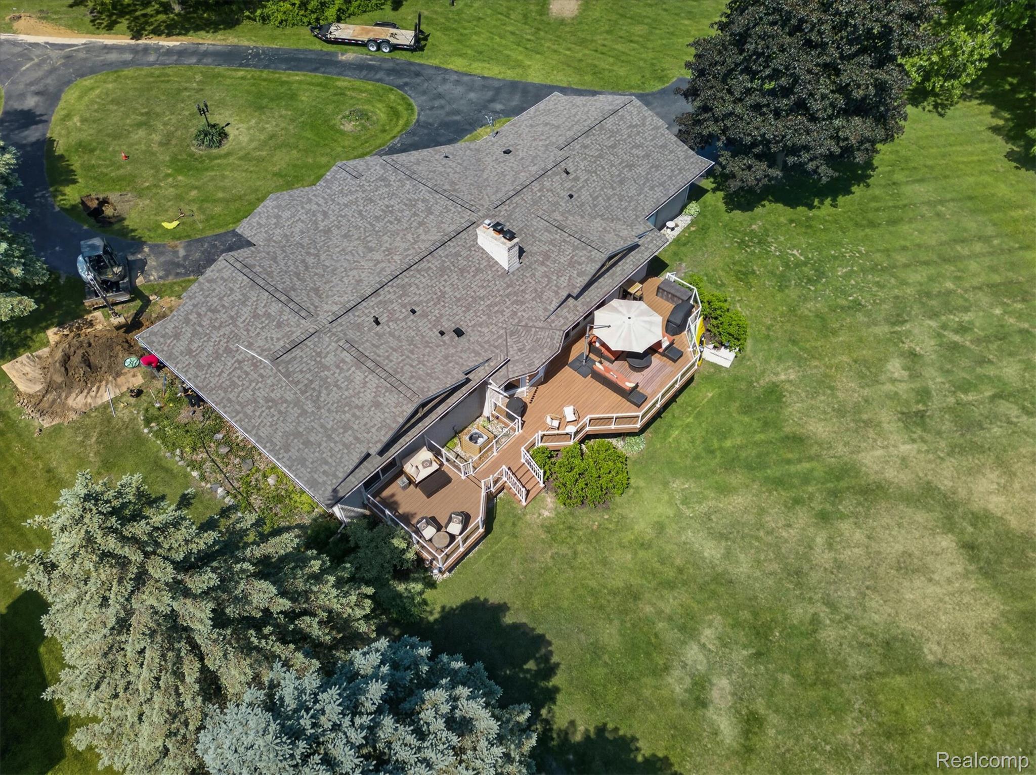 3860 East Commerce Road Commerce Township, MI 48382 - Photo 65 of 72 Aerial perspective highlighting a multi-level wood-finish deck with integrated railings and steps