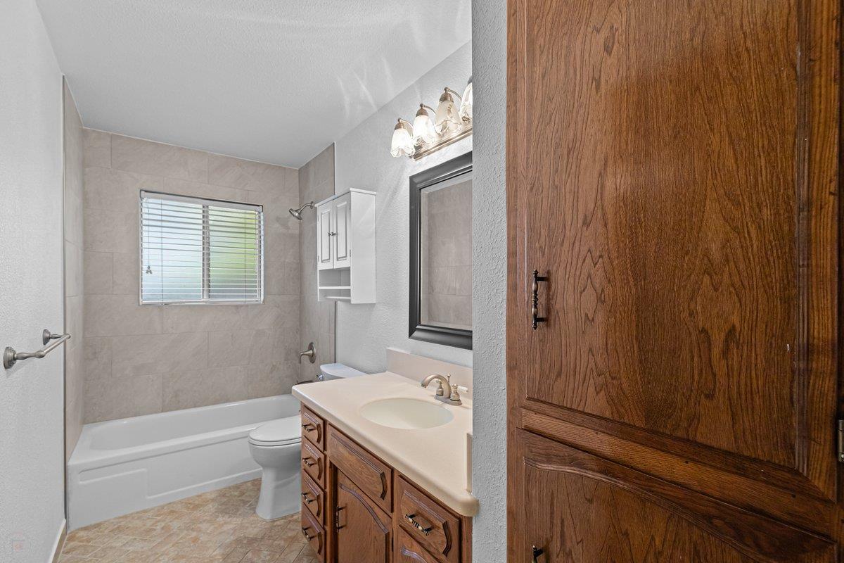 244 California Street Ripon, CA 95366 - Photo 26 of 34 a bathroom with a sink a toilet and shower