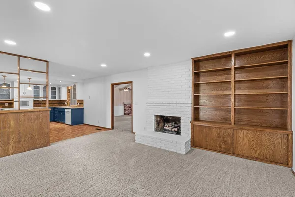 a view of kitchen with furniture and a fireplace