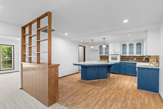 a kitchen with stainless steel appliances kitchen island wooden cabinets and granite counter tops