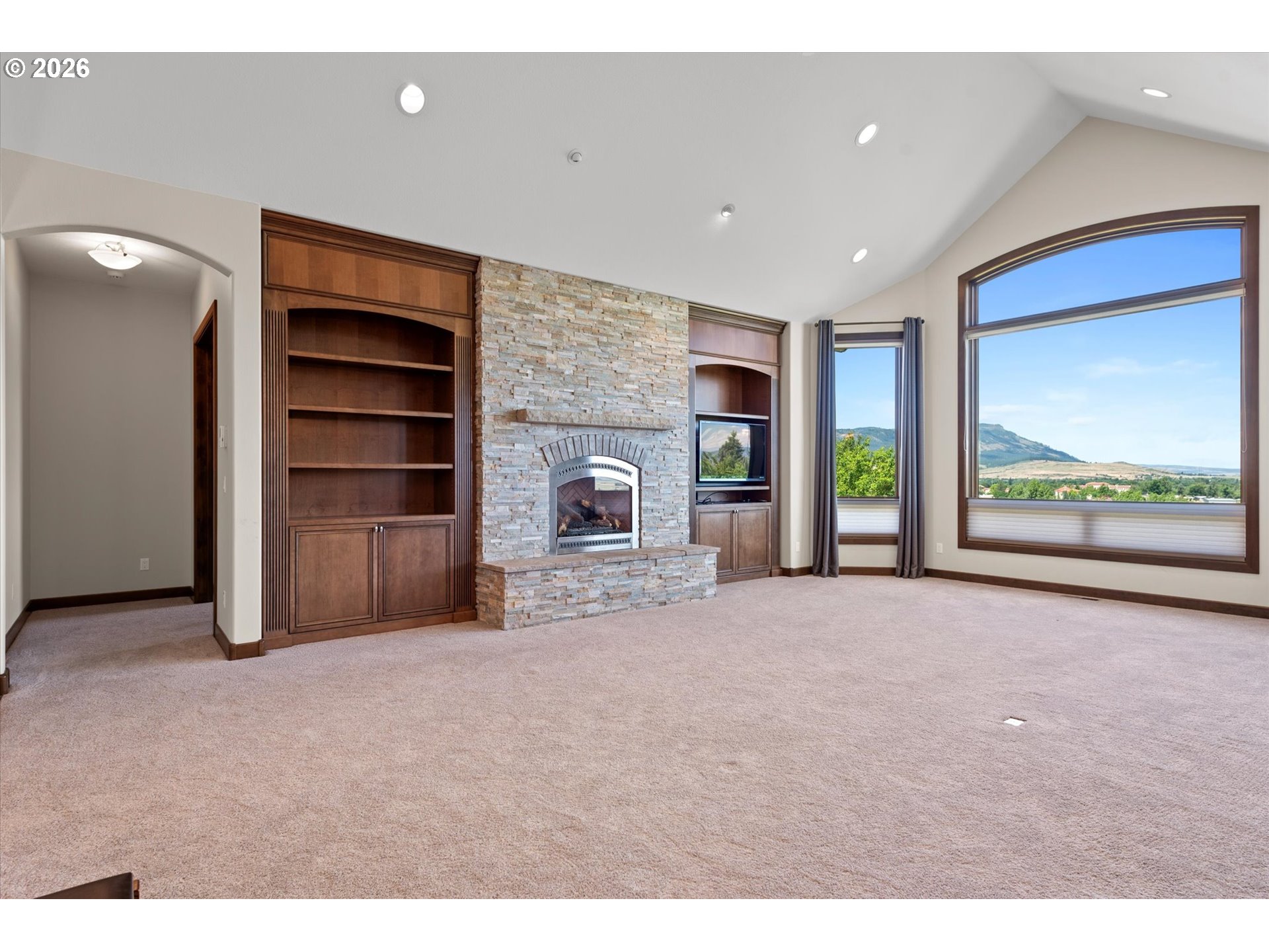 121 Ridge Drive La Grande, OR 97850 - Photo 13 of 43 a view of an empty room with a fireplace and a window