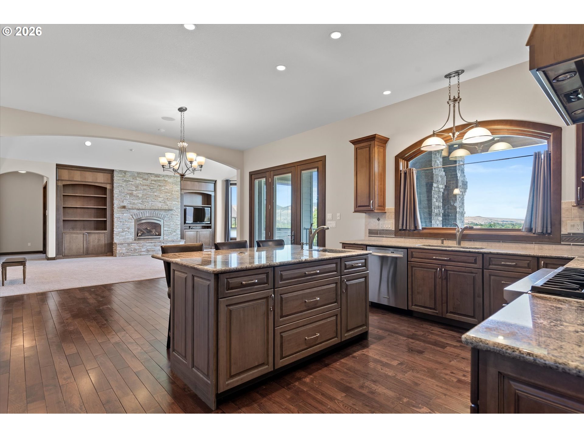 121 Ridge Drive La Grande, OR 97850 - Photo 18 of 43 a kitchen with granite countertop a stove and a wooden floors