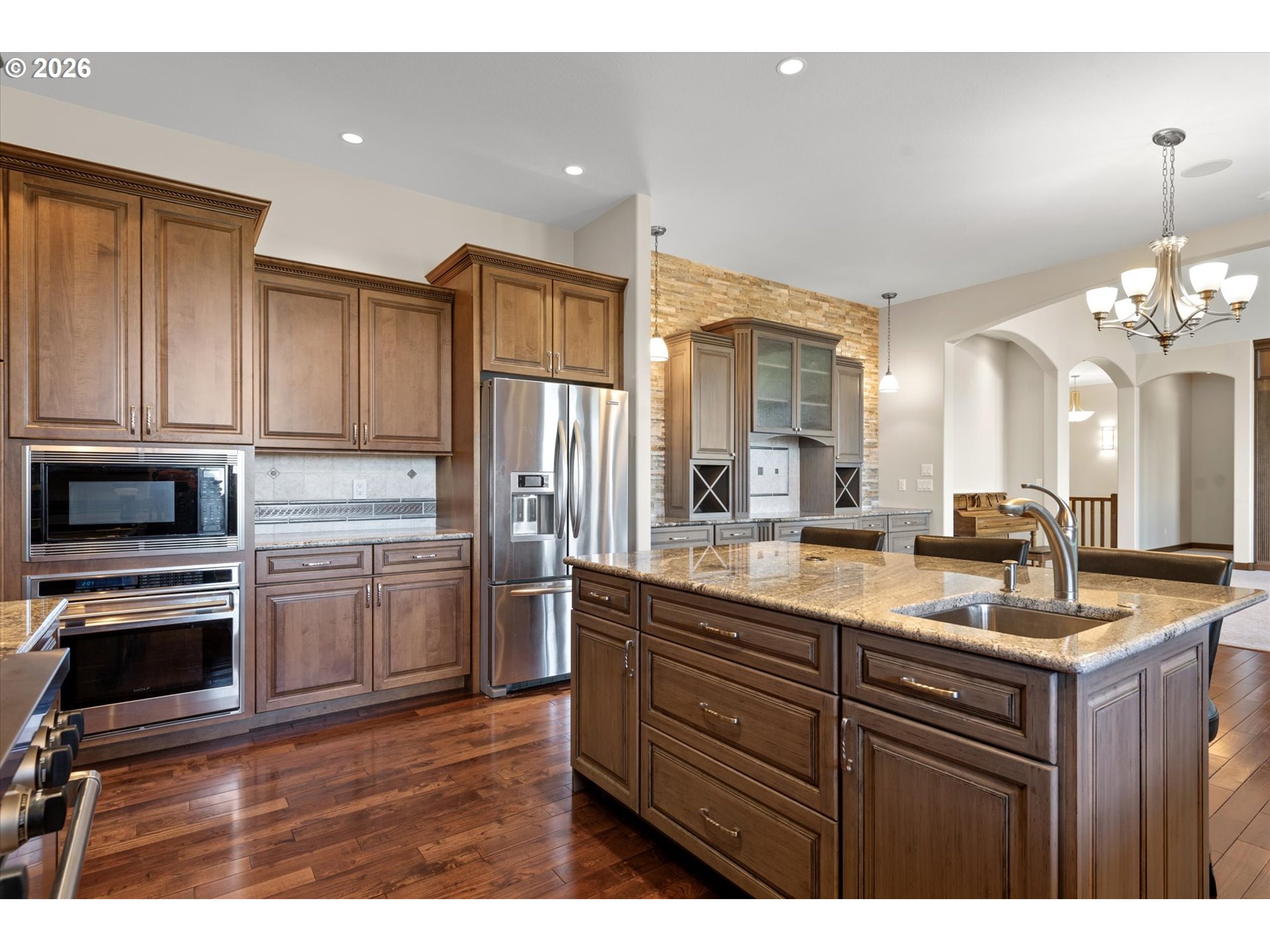 121 Ridge Drive La Grande, OR 97850 - Photo 19 of 43 a kitchen with kitchen island granite countertop a sink cabinets and stainless steel appliances
