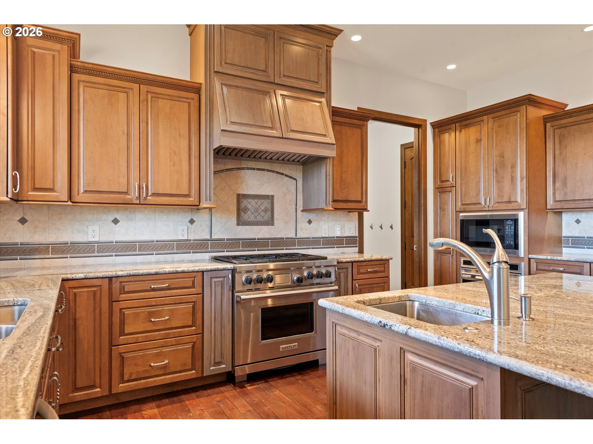 121 Ridge Drive La Grande, OR 97850 - Photo 20 of 43 a kitchen with stainless steel appliances granite countertop a stove a sink and a microwave