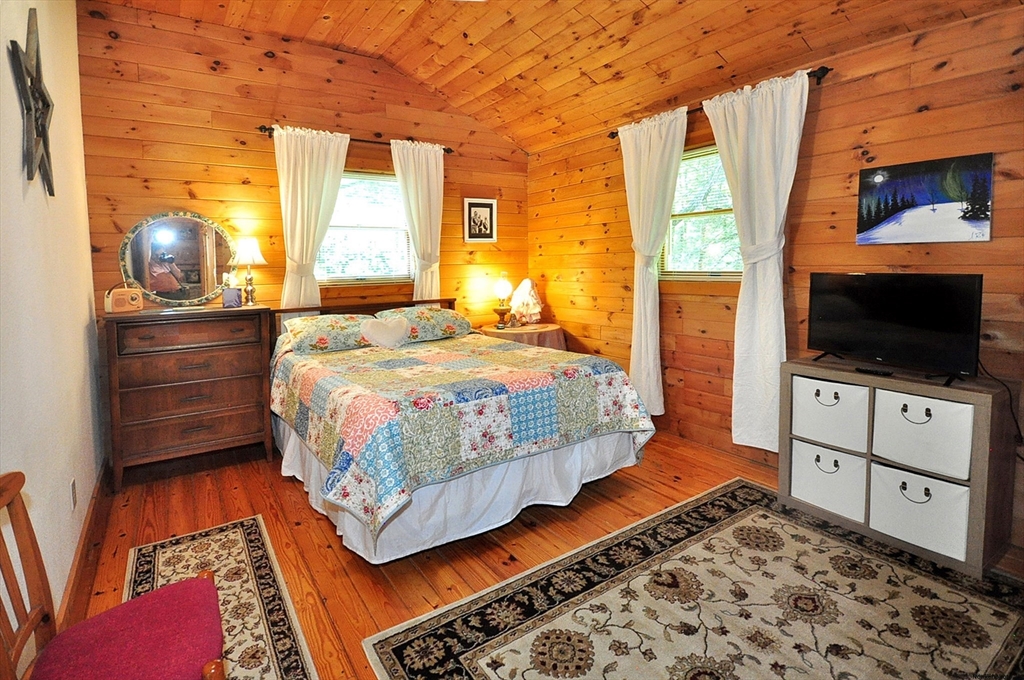 15 Thicket Road Tolland, MA 01034 - Photo 33 of 42 a bedroom with a bed and flat screen tv