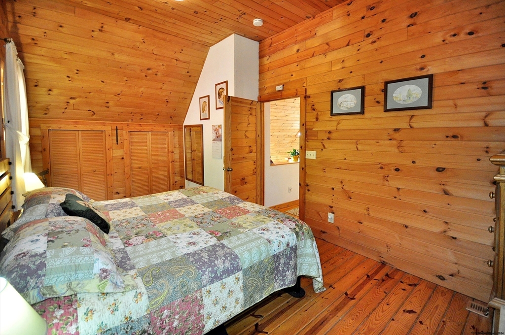 15 Thicket Road Tolland, MA 01034 - Photo 37 of 42 a bedroom with a bed and wooden floor