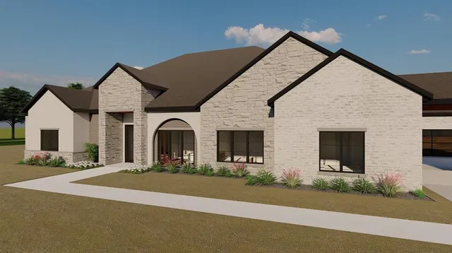 a front view of a house with yard and green space