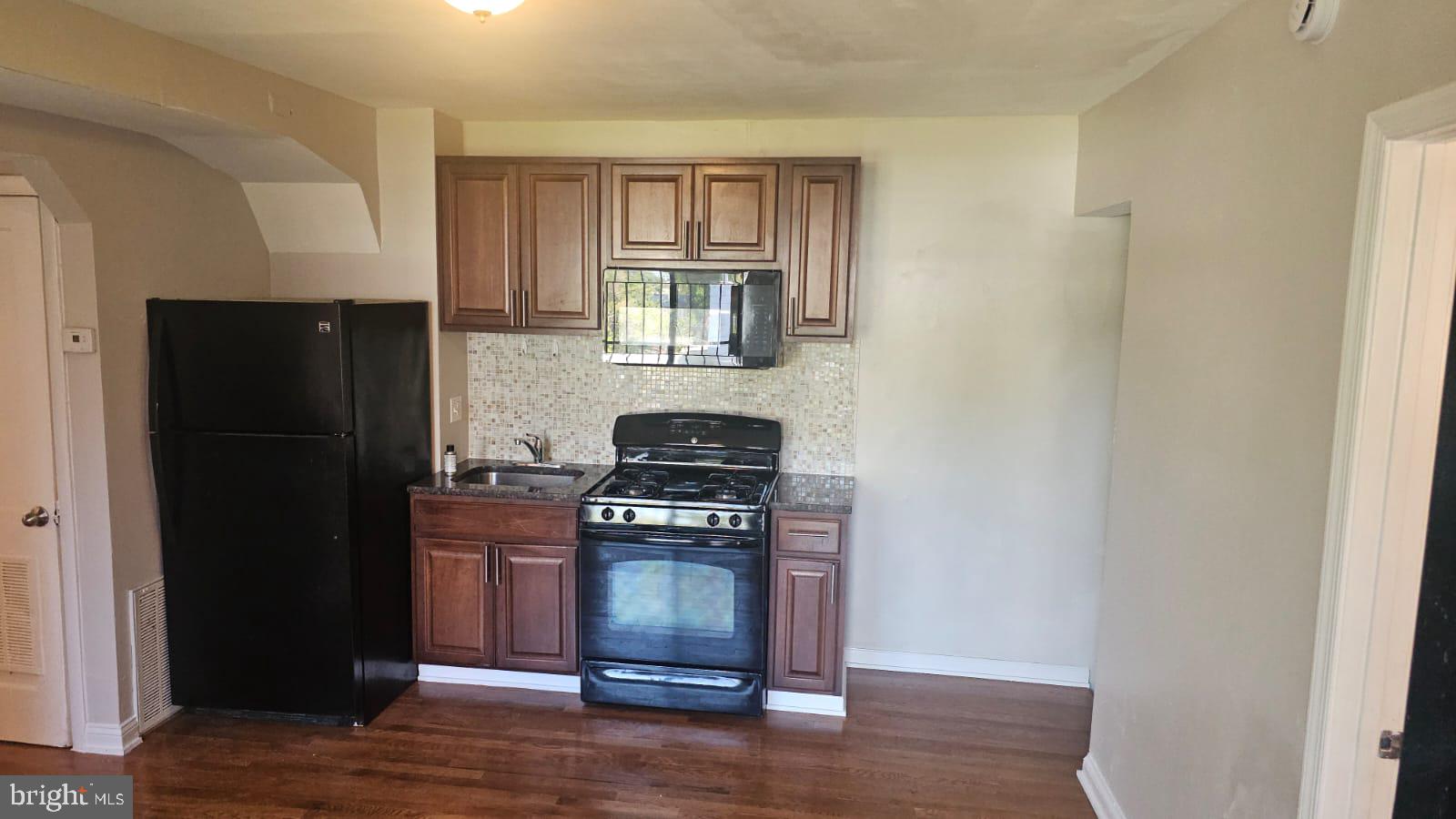 a kitchen with a stove and a refrigerator