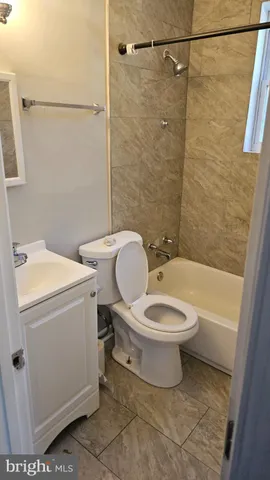 a bathroom with a toilet a sink and a shower