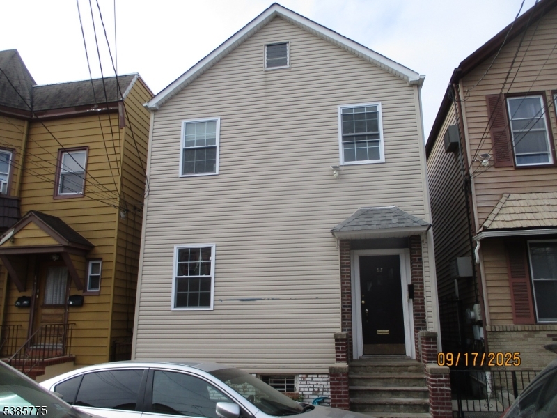 63 Warwick Street Newark, NJ 07105 - Photo 1 of 17 a front view of a house with parking