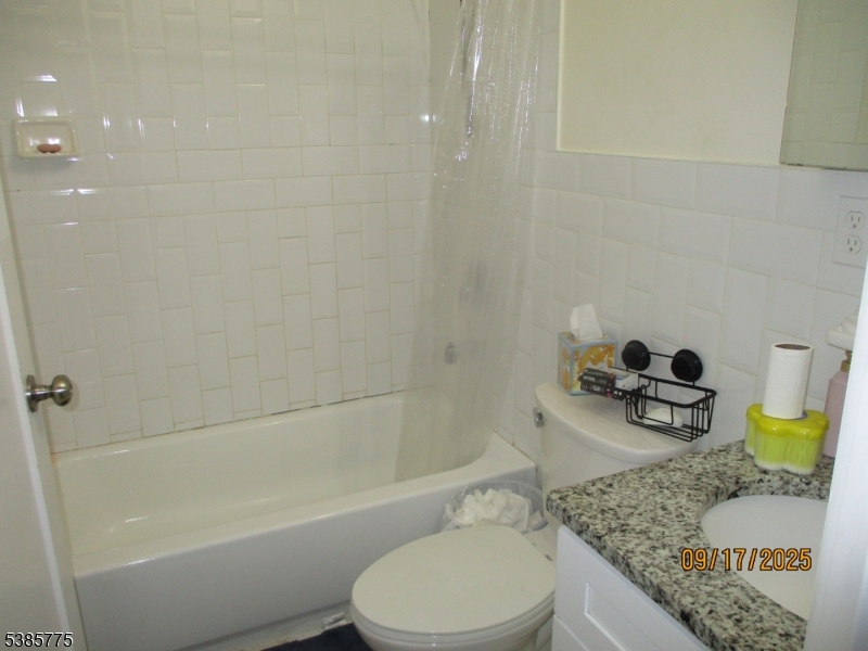 63 Warwick Street Newark, NJ 07105 - Photo 15 of 17 a bathroom with a granite countertop bathtub sink vanity and toilet