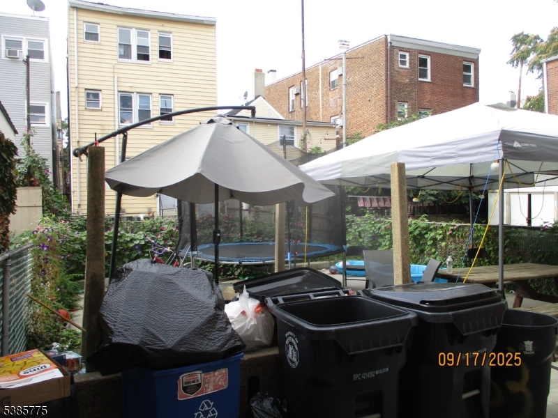 63 Warwick Street Newark, NJ 07105 - Photo 17 of 17 a backyard of a house with yard and outdoor seating
