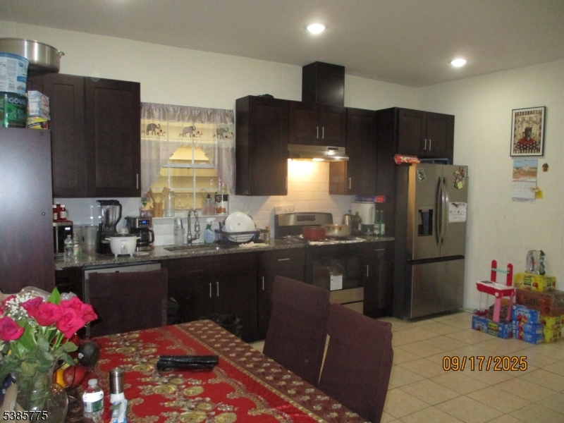 63 Warwick Street Newark, NJ 07105 - Photo 2 of 17 a kitchen with refrigerator and sink
